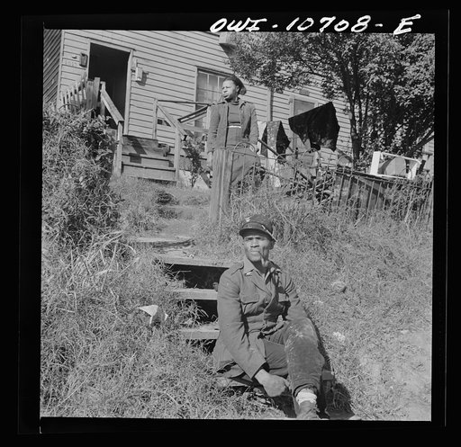 Washington, D.C. Mr. and Mrs. Venus Alsobrook in front of their home in the southwest section. Mr. Alsobrook is an official salvage collector for the government