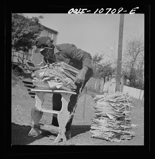 Washington, D.C. Mr. Venus Alsobrook, official salvage collector for the government wrapping old papers which he has gathered from all sections of the city