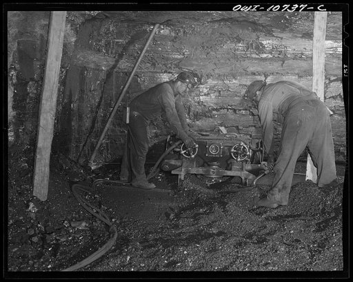 Pittsburgh, Pennsylvania (vicinity). Montour no. 4 mine of the Pittsburgh Coal Company. After a face of coal has been "cleaned up', an electrically driven cutter undercuts the face with a three foot deep cut. Above this undercut, and near the roof of the face, holes are drilled which take the powder