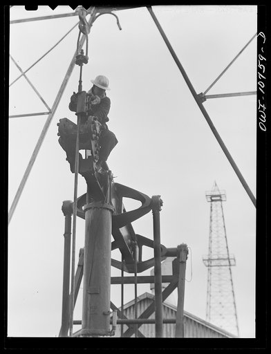 Oklahoma City, Okla. Repairing a pump on an oil well