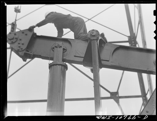 Oklahoma City, Oklahoma. Repairing a pump on an oil well