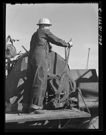 Untitled photo, possibly related to: Oklahoma City, Oklahoma. Cable operated from the back of a truck for pulling rods and tubing in cleaning out oil wells