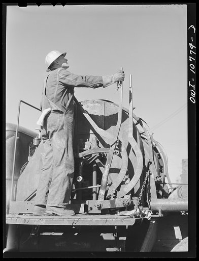Oklahoma City, Oklahoma. Cable operated from the back of a truck for pulling rods and tubing in cleaning out oil wells
