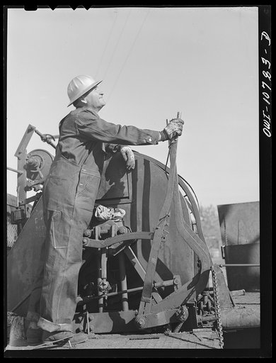 Oklahoma City, Oklahoma. Cable operated from the back off a truck for pulling rods and tubing in cleaning out oil wells