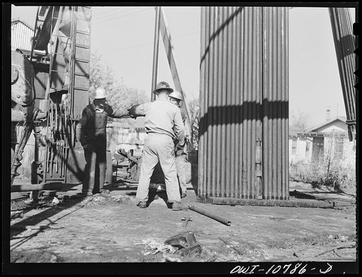 Untitled photo, possibly related to: Oklahoma City, Oklahoma. Tubing and rods removed from an oil well for repairing
