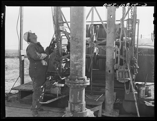 Untitled photo, possibly related to: Moore County, Texas. Adding another length of pipe during rotary drilling operations