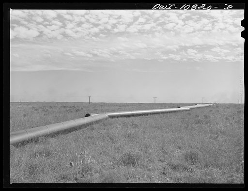 Moore County, Texas. Pipe strung out awaiting trench digging crew