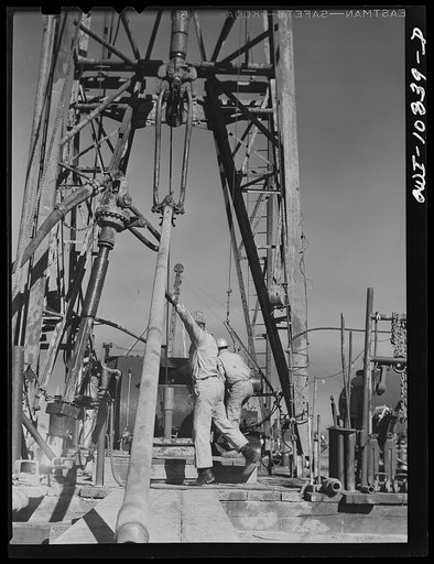 Moore County, Texas. Adding length of pipe to drill stem during rotary drilling operations