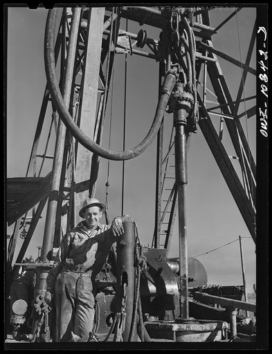 Moore County, Texas. Driller at an oil well being drilled with a portable rotary drilling outfit