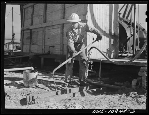 Untitled photo, possibly related to: Moore County, Texas. Driller at an oil well being drilled with a portable rotary drilling outfit