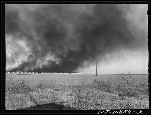 Moore County, Texas. Oil company production camp with smoke from carbon black plant