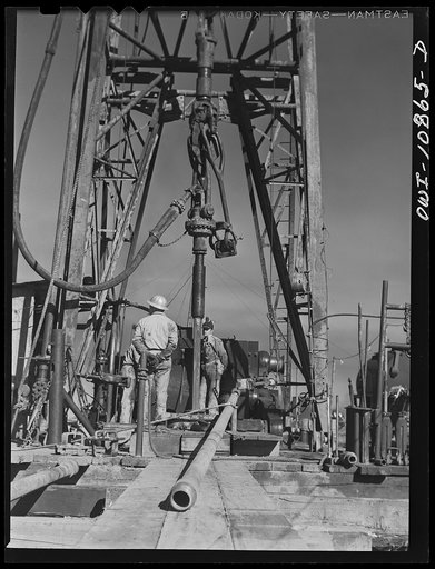 Moore County, Texas. Preparing to add a length of drill pipe to drill stem during rotary drilling operations