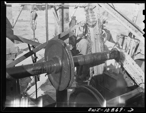 Untitled photo, possibly related to: Moore County, Texas. Driller at an oil well being drilled with a portable rotary drilling outfit