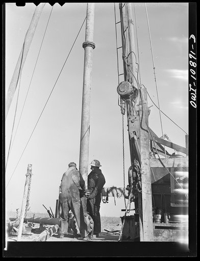 Untitled photo, possibly related to: Moore County, Texas. Preparing to add a length of drill pipe to drill stem during rotary drilling operations