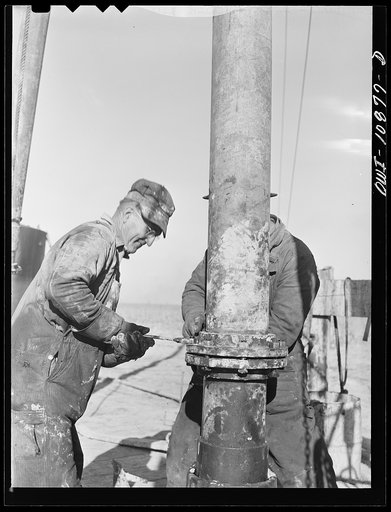 Untitled photo, possibly related to: Moore County, Texas. Adding length of pipe during rotary drilling operations