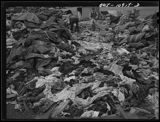 Lancaster, Pennsylvania. Everyone was asked to dump his scrap in a vacant lot at the center of town. It was then bought by a junk man and salvaged. Rags being sorted; those damp from rain are hung up to dry