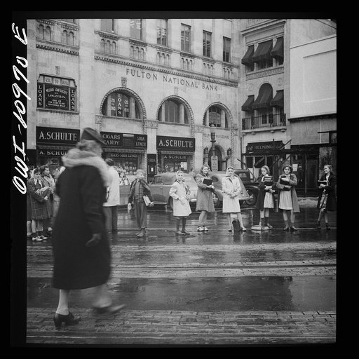 Lancaster, Pennsylvania. School children waiting for buses in the rain