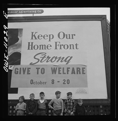 Lititz (vicinity), Pennsylvania. Boys playing near a billboard. Most of their fathers work in nearby defense plants