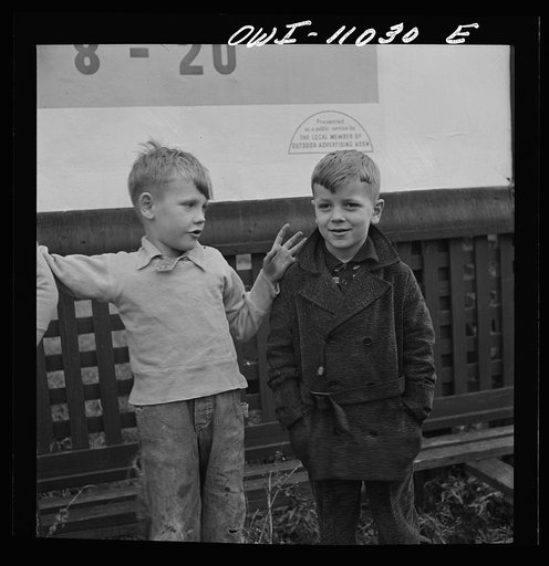 Lititz (vicinity), Pennsylvania. Boys playing near a billboard. Most of their fathers work in nearby defense plants