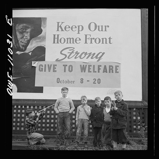 Untitled photo, possibly related to: Lititz (vicinity), Pennsylvania. Boys playing near a billboard. Most of their fathers work in nearby defense plants