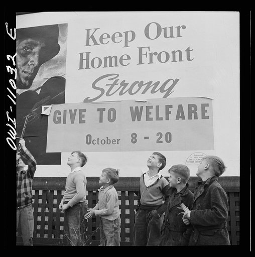 Lititz (vicinity), Pennsylvania. November 1942. Boys playing near a billboard. Most of their fathers work in nearby defense plants