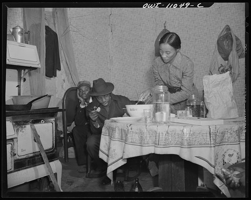 Washington (southwest section), D.C. A mother preparing dinner in a one-room flat