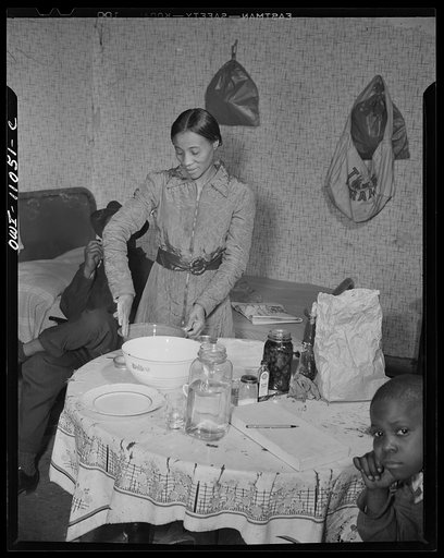 Washington (southwest section), D.C. A mother preparing dinner in a one-room flat