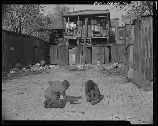 Washington (southwest section), D.C. Two Negro boys shooting marbles in front of their home