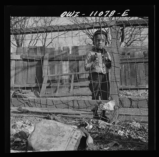 Washington (southwest section), D.C. Boy playing in the backyard of his home
