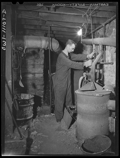 Untitled photo, possibly related to: Lititz, Pennsylvania. This town of 400-odd inhabitants, has two weekly papers, the oldest of which is the Record-express. Pouring molten metal, to make plates from mats in the basement of the Record-express office building