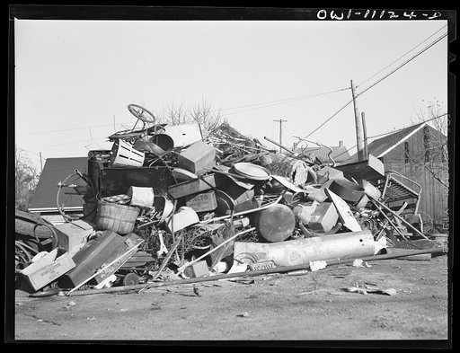 Untitled photo, possibly related to: Lititz, Pennsylvania. A furniture dealer, who is chairman of the salvage committee, supervising the scrap collection. The object at right is a dentist's chair