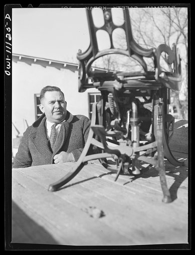 Untitled photo, possibly related to: Lititz, Pennsylvania. A furniture dealer, who is chairman of the salvage committee, supervising the scrap collection. The object at right is a dentist's chair