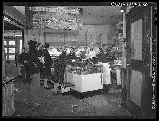 Untitled photo, possibly related to: Lititz, Pennsylvania. Butcher shop of Benjamin Lutz (second from right) at 4:30 p.m. when shifts change at the factories. Although there is no scarcity of meat in Lancaster County yet, the wholesale price has risen as much as from five to eight cents a pound