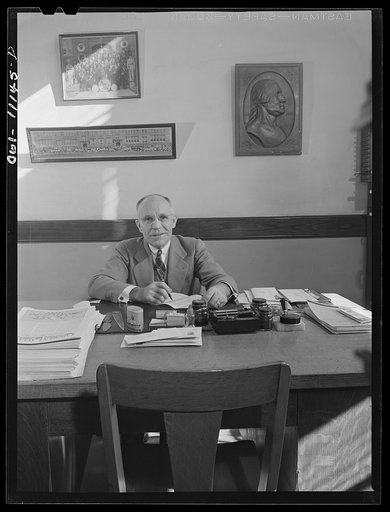 Lititz, Pennsylvania. Mr. M.C. Demmy, Principal of the Lititz Borough School, and the president of the Chamber of Commerce, in his school office where he has just received a letter from the government asking him to turn in one-third of the school's typewriters