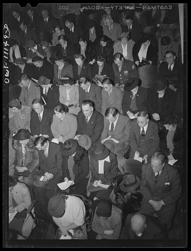 Lititz, Pennsylvania. Armistice Day gathering in Lilitz. Audience bows its heads in tribute to boys in the service. Note one home on leave in third row from rear