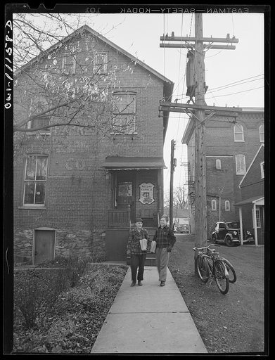 Untitled photo, possibly related to: Lititz, Pennsylvania. Most copies of the Lititz Record-express are mailed to subscribers. Newsstand copies are distributed by schoolboys after 3 p.m.