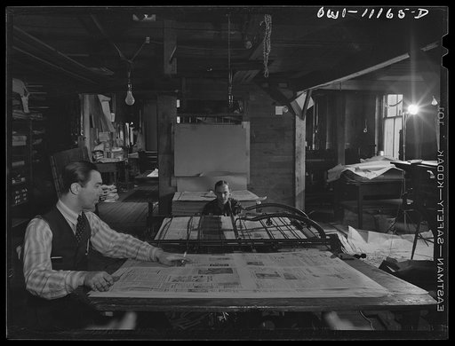 Lititz, Pennsylvania. Cutting and folding machine in the Lititz Record-express office. Owner and publisher William N. Young (foreground), who is short of help, feeds the papers himself