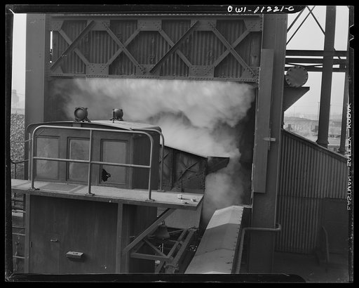 Hanna furnaces of the Great Lakes Steel Corporation. Steam rising in quenching tower after water has been poured onto the live coke