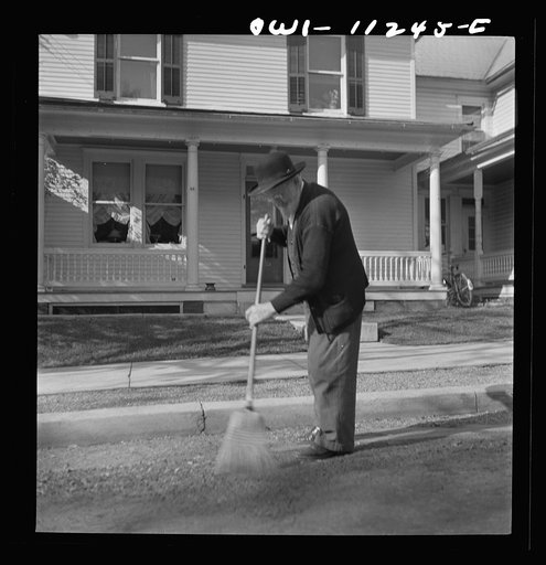 Untitled photo, possibly related to: Lititz, Pennsylvania. Old Mennonite sweeping leaves