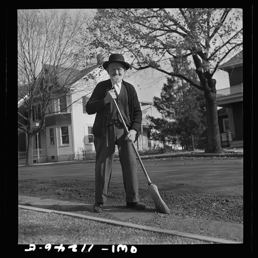 Lititz, Pennsylvania. Old Mennonite sweeping leaves