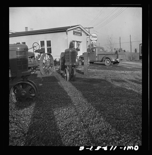 Untitled photo, possibly related to: Lititz, Pennsylvania. "Frozen" brand new tractors displayed outside Diem's farm machinery store. No more farm machinery can be sold since November 1. They hope for some kind of rationing before spring