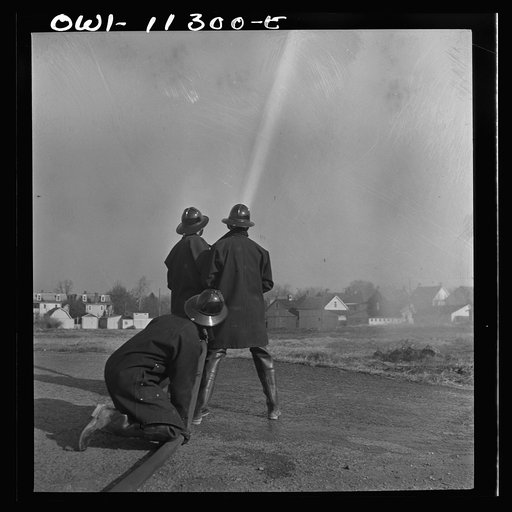Lititz, Pennsylvania. Volunteer firemen practicing in a vacant lot during an air raid drill