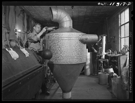 Lititz, Pennsylvania. Machine shop back of Morris Kreider's hardware store where he makes small parts for neighboring defense plants. Here he is working on a "cyclone" or dust collector for the Hackman Furniture Company, now making propellors. Kreider expects his hardware business to fold due to lac