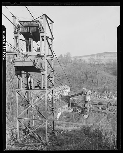 Pittsburgh, Pennsylvania (vicinity). Montour no. 4 mine of the Pittsburgh Coal Company. Slate is loaded into separate cars in the mine and when the "trips" come into the tripple, the slate is dumped onto a conveyor belt which dumps it into moving overhead cars which carry the refuse a mile up the hi