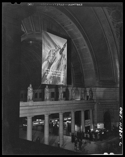 Untitled photo, possibly related to: Washington, D.C. Interior of the Union Station with an OWI (Office of War Information) banner in the background