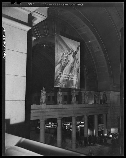 Untitled photo, possibly related to: Washington, D.C. Interior of the Union Station with an OWI (Office of War Information) banner in the background
