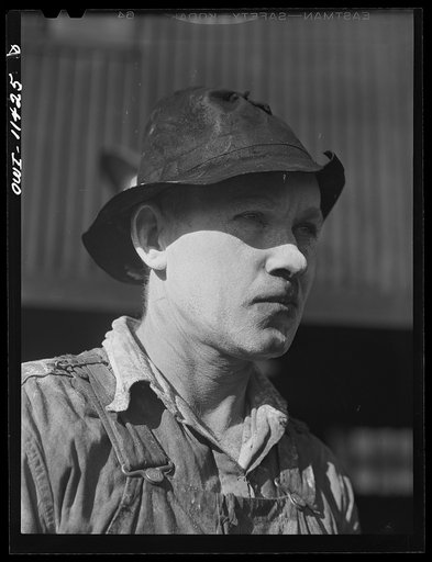 Sunray, Texas. Worker at a carbon black plant with cream spread on his face to protect it from the black dust