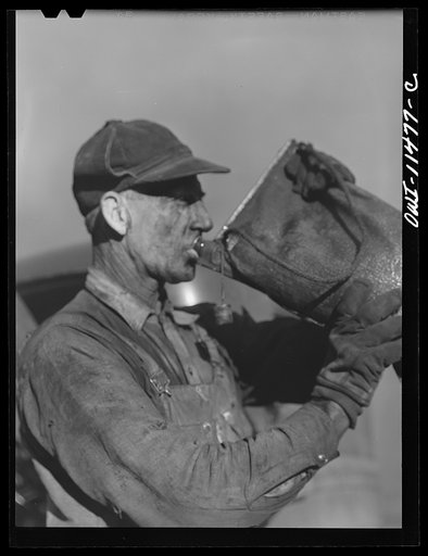 Sunray, Texas. Carbon black plant worker getting a drink of water