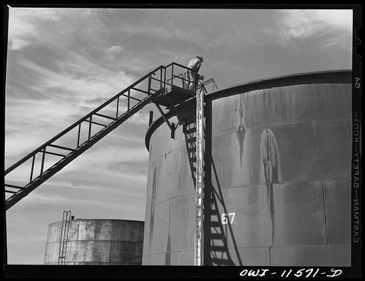 Phillips gasoline plant. Borger, Texas. Taking sample from a storage tank