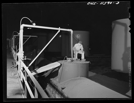 Phillips gasoline plant. Borger, Texas. Taking a sample of gasoline from tank car just loaded